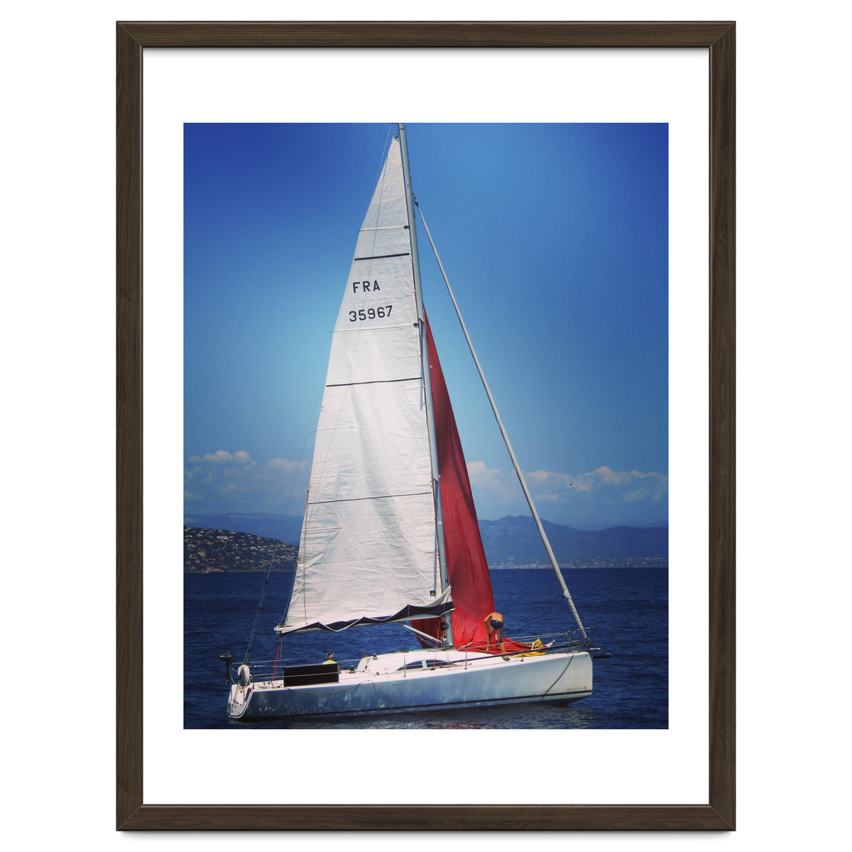 Sailing yacht with white and red sails