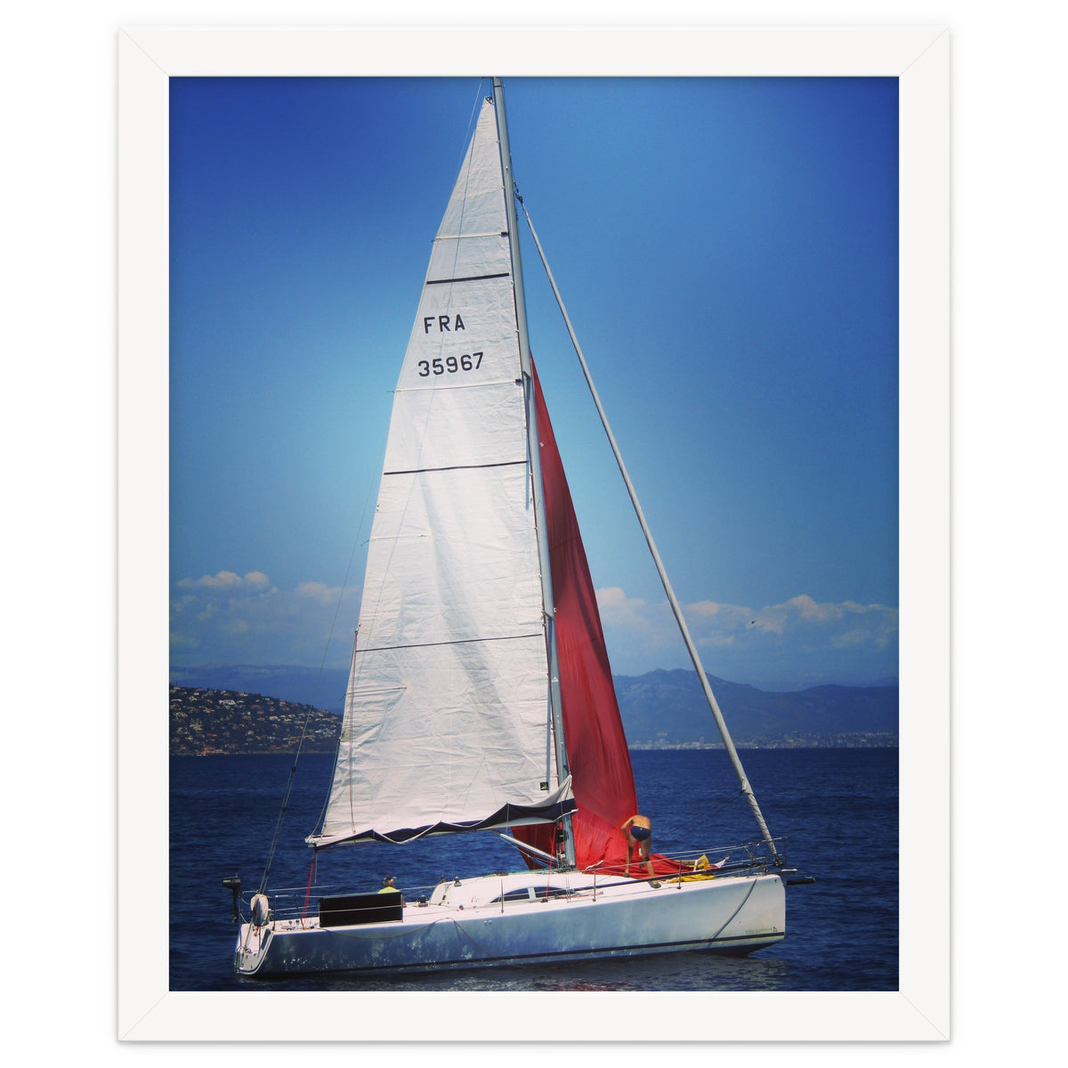 Sailing yacht with white and red sails