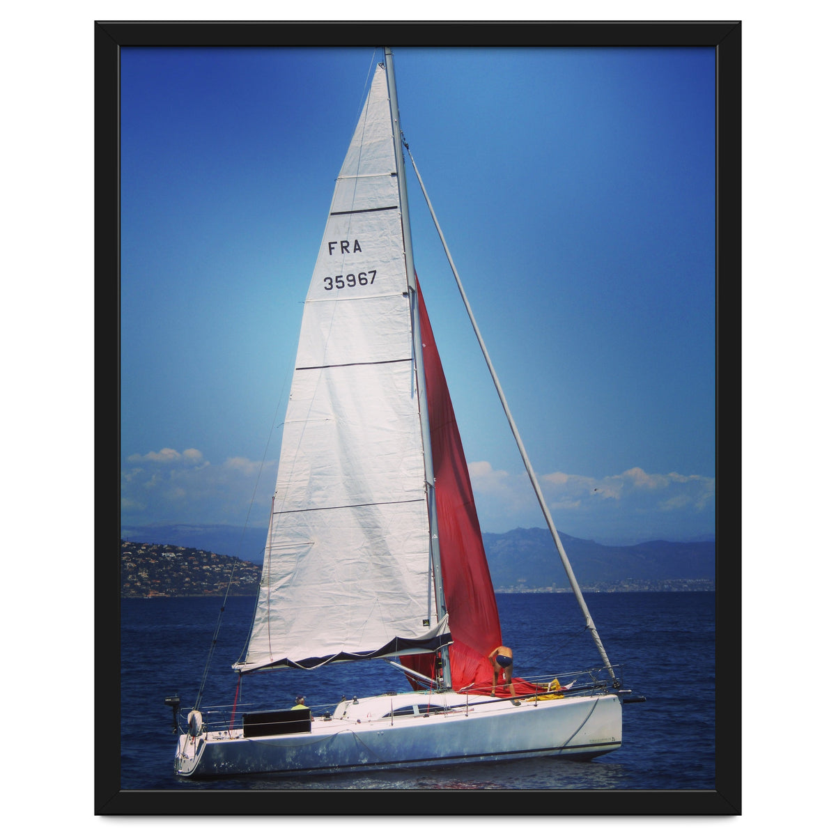 Sailing yacht with white and red sails