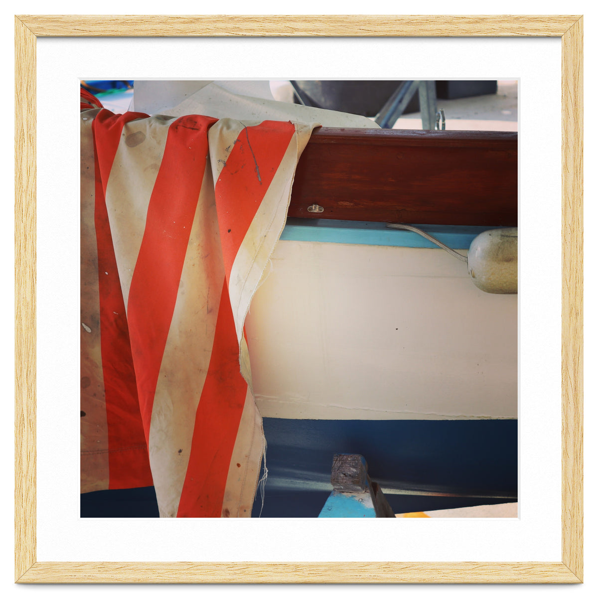 Fishing boat and striped sail